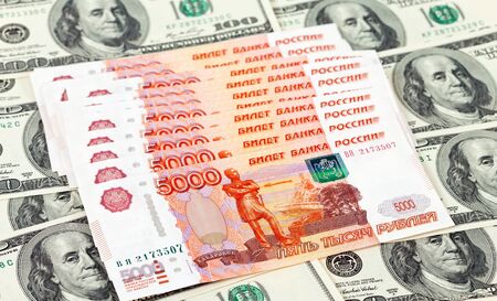 Russian roubles bills laying over dollars backgroundの写真素材
