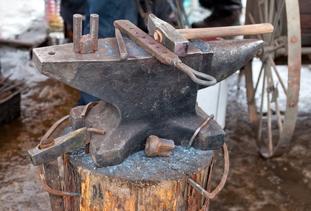 Old anvil with blacksmith tools on the outdoorsの写真素材