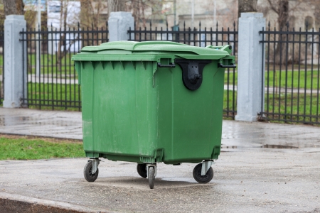 Green recycling container on the street of cityの写真素材