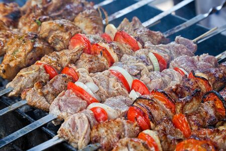 Juicy slices of meat with sauce prepare on fire (shashlik)の写真素材