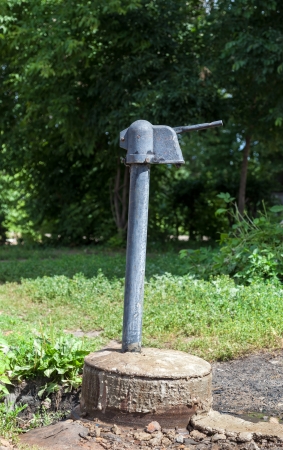 Old public hand water pump outdoorsの写真素材