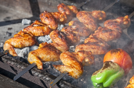 Juicy slices of meat with sauce prepare on fire (shish kebab)の写真素材