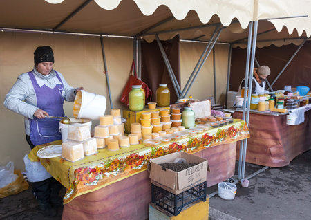 SAMARA, RUSSIA - OCTOBER 20: Women seller of honey on the traditional market October 20, 2013 in Samara, Russia. のeditorial素材