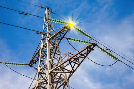 High voltage electric tower against blue skyの写真素材