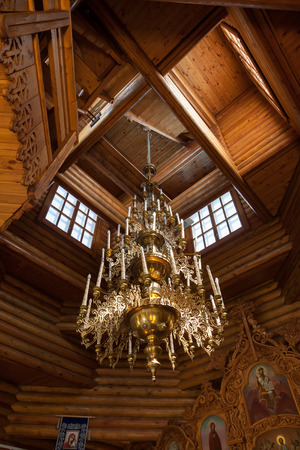 Electric chandelier in the wooden churchのeditorial素材