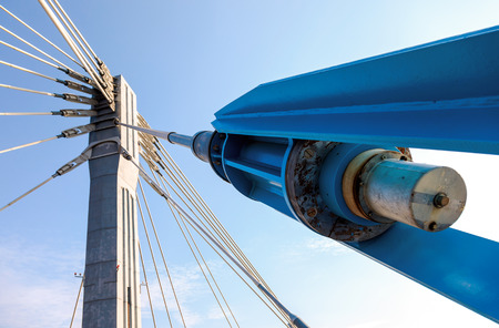 Modern cable bridge pylon against blue skyの写真素材