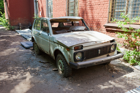SAMARA, RUSSIA - MAY 22, 2013: Abandoned broken russian automobile Lada at the abandoned town in summertimeのeditorial素材