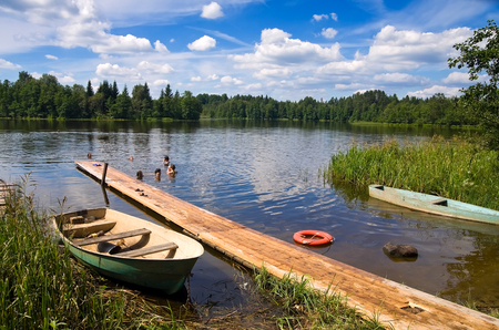 BOROVICHI, RUSSIA - JULY 21, 2014: Children swimming in the lake in summer sunny dayのeditorial素材