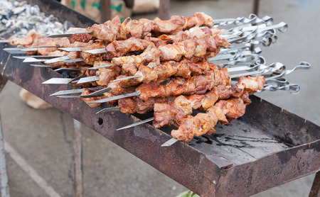 Appetizing fresh meat shish kebab (shashlik) prepared on a grill wood coal, outdorの写真素材