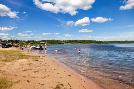 NOVGOROD REGION, RUSSIA - JULY 20,2014: People relax on the lake in summer sunny dayのeditorial素材