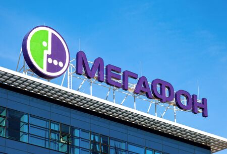 SAMARA, RUSSIA - SEPTEMBER 13, 2015: Logo of MegaFon against blue sky. MegaFon is second largest mobile phone operator in Russiaのeditorial素材
