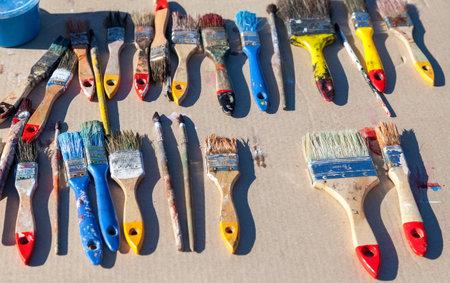Dirty old paint brushes on the table