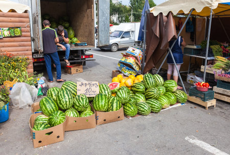 SAMARA, RUSSIA - AUGUST 29, 2015: Fresh watermelons and vegetables ready to sale at the local farmers marketのeditorial素材
