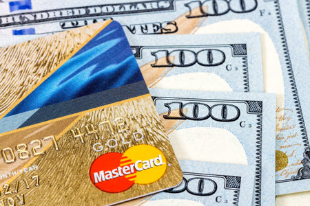 SAMARA, RUSSIA - NOVEMBER 15, 2015: MasterCard Credit Card with US dollar billsのeditorial素材