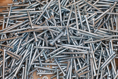Chrome metal fastening bolts as backgroundの写真素材