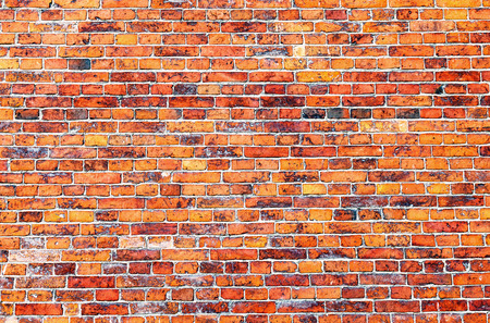 Old weathered red brick wall as backgroundの写真素材