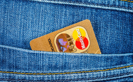 SAMARA, RUSSIA - DECEMBER 23, 2015: Credit card MasterCard sticking out of the back jeans pocket