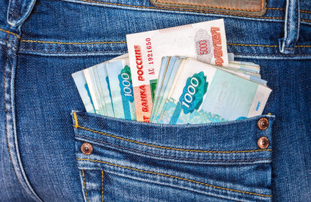 SAMARA, RUSSIA - DECEMBER 23, 2015: Russian rouble banknotes sticking out of the back jeans pocket