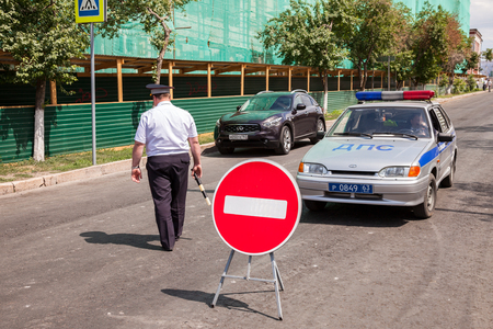 SAMARA, RUSSIA - JUNE 16, 2015: Russian police officer and patrol vehicle parked at the street in summer dayのeditorial素材