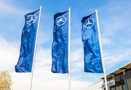 TOGLIATTI, RUSSIA - MAY 3, 2015: Dealership flags of Mercedes-Benz over blue sky near the office of official dealer. Mercedes-Benz is a German automobile manufacturerのeditorial素材