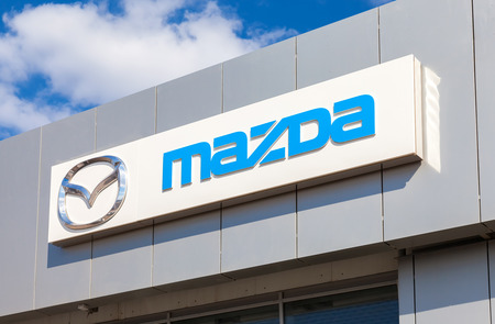SAMARA, RUSSIA - MAY 11, 2016: Mazda logo on the facade of official dealer office. Mazda Motor Corporation is a Japanese car brand, automotive manufacturerのeditorial素材