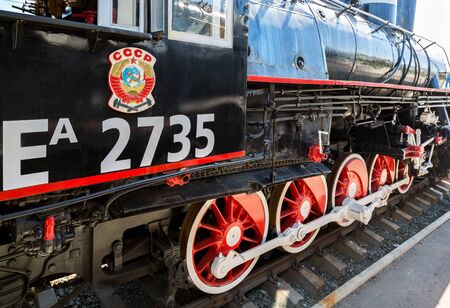 Samara, Russia - April 29, 2017: Russian retro steam locomotive with symbol of former state the USSR and red wheelsのeditorial素材