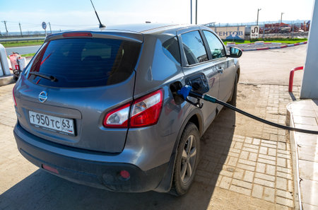Samara, Russia - April 30, 2017: Pumping gasoline fuel in passenger car at gas stationのeditorial素材