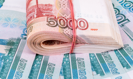 Folded stack of five thousandths banknotes of russian roubles on money backgroundの写真素材