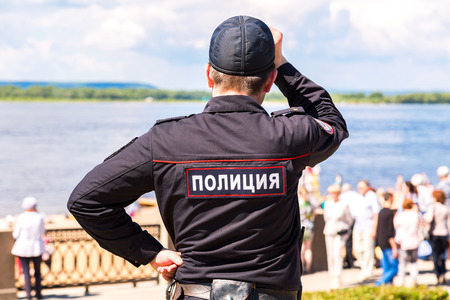 Samara, Russia - May 12, 2017: Unidentified Russian police officer in uniform at the embankment of Volga river. Text in russian: "Police"のeditorial素材