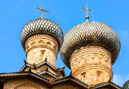 Wooden dome with orthodox cross of ancient russian church against the blue sky in Novgorod, Russiaの写真素材