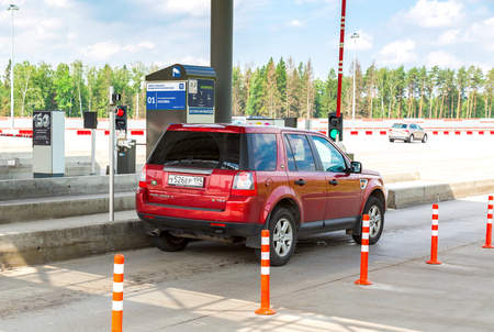 Moscow, Russia - July 16, 2017: Cars passing through the automatic point of payment on a toll road. Russian highway number M11のeditorial素材