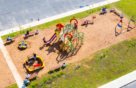 Veliky Novgorod, Russia - August 17, 2017: Colorful children's playground for kids in new residential area with sand, many slides, swings, toys for playのeditorial素材