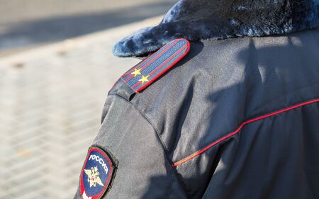 Samara, Russia - November 16, 2017: Chevron on the sleeve winter uniforms and shoulder strap of the russian policemanのeditorial素材