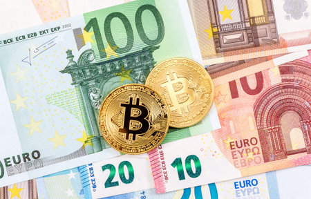 Cryptocurrency of the Bitcoin lying on the euro banknotes. Business concept of new virtual money