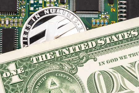 Digital cryptocurrency Litecoin, electronic computer component and american dollar. Business concept of new virtual moneyの写真素材