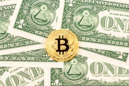 Physical version of Bitcoin on the american dollars. Business concept of worldwide cryptocurrency