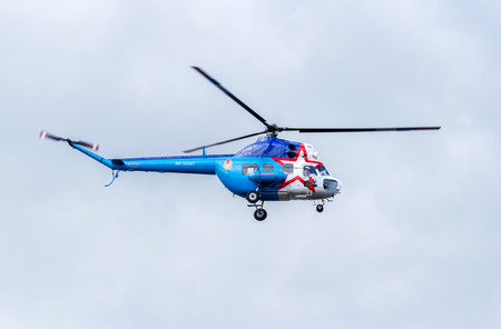 Samara, Russia - September 10, 2017: Russian Air Force Mi-2 helicopter flying against cloudy skyのeditorial素材