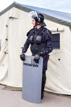 Samara, Russia - September 10, 2017: Special Forces soldier of Rosgvardia in uniform with shield and helmet. Rosgvardia is the internal military force of the government of Russia. Text in Russian: Rosgvardiaのeditorial素材
