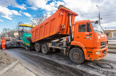 Samara, Russia - April 29, 2018: Work on laying the asphalt surface on a city street. Machines for transportation and laying of asphaltのeditorial素材
