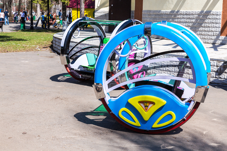 Samara, Russia - May 2, 2018: Attraction Happy swing car with electric wheels in public parkのeditorial素材