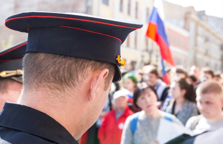 Samara, Russia - May 5, 2018: Russian police officer against the crowd during an opposition protest rally at the city streetのeditorial素材