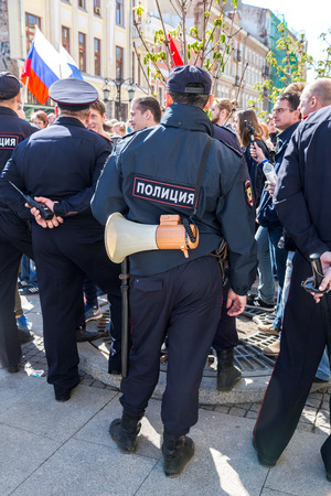 Samara, Russia - May 5, 2018: Russian policeman with megaphone speaker during an opposition protest rally. Text in russian: Policeのeditorial素材