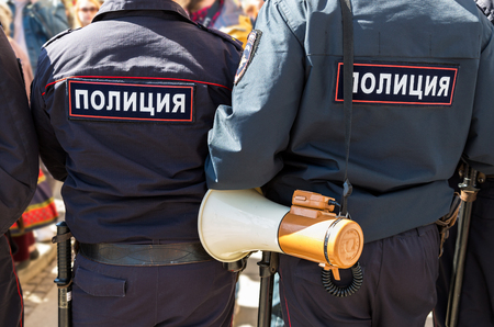 Samara, Russia - May 5, 2018: Russian policeman with megaphone speaker during an opposition protest rally. Text in russian: Policeのeditorial素材