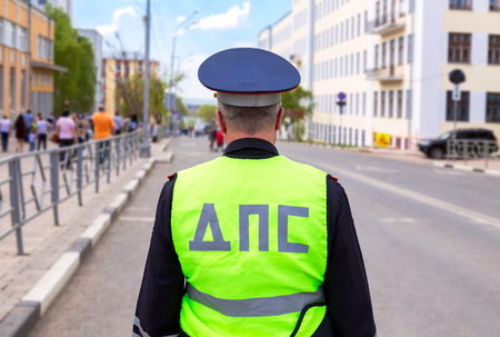 Samara, Russia - May 9, 2018: Russian police patrol officer of the State Automobile Inspectorate regulate traffic on city streetのeditorial素材