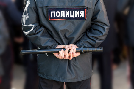 Russian policeman with police truncheon. Text in russian: Policeの写真素材