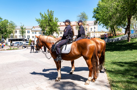 Samara, Russia - May 27, 2018: Female mounted police on horse back at the city streetのeditorial素材