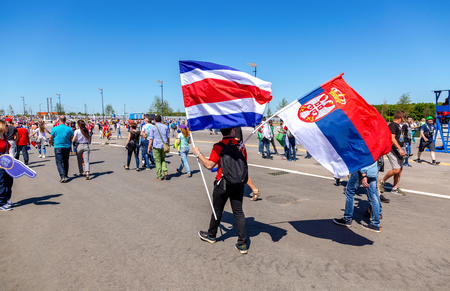Samara, Russia - June 17, 2018: Football fans with flags of Costa Rica and Serbia near the stadium during the 2018 FIFA World Cupのeditorial素材