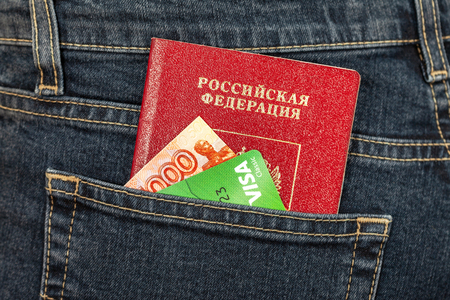 Samara, Russia - November 24, 2017: Russian passport, money and credit card Visa in back jeans pocket. Travel conceptのeditorial素材