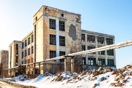 Old abandoned and destroyed building in sunny winter dayの写真素材