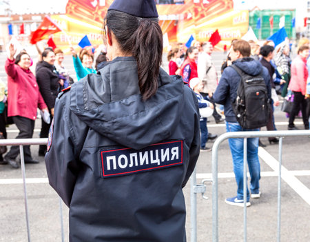 Samara, Russia - May 1, 2018: Unidentified Russian policewoman in uniform watching the rule of law...